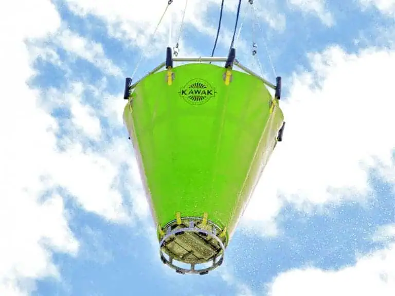 Green aerial firefighting water bucket in the sky