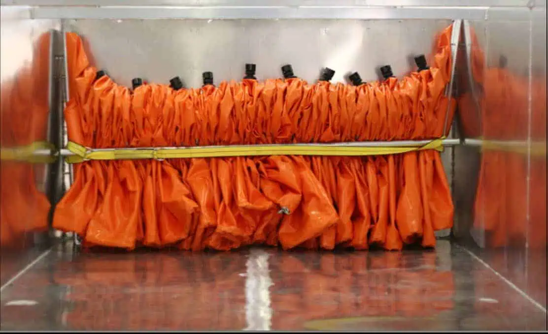 Orange inflatable inside a metallic chamber