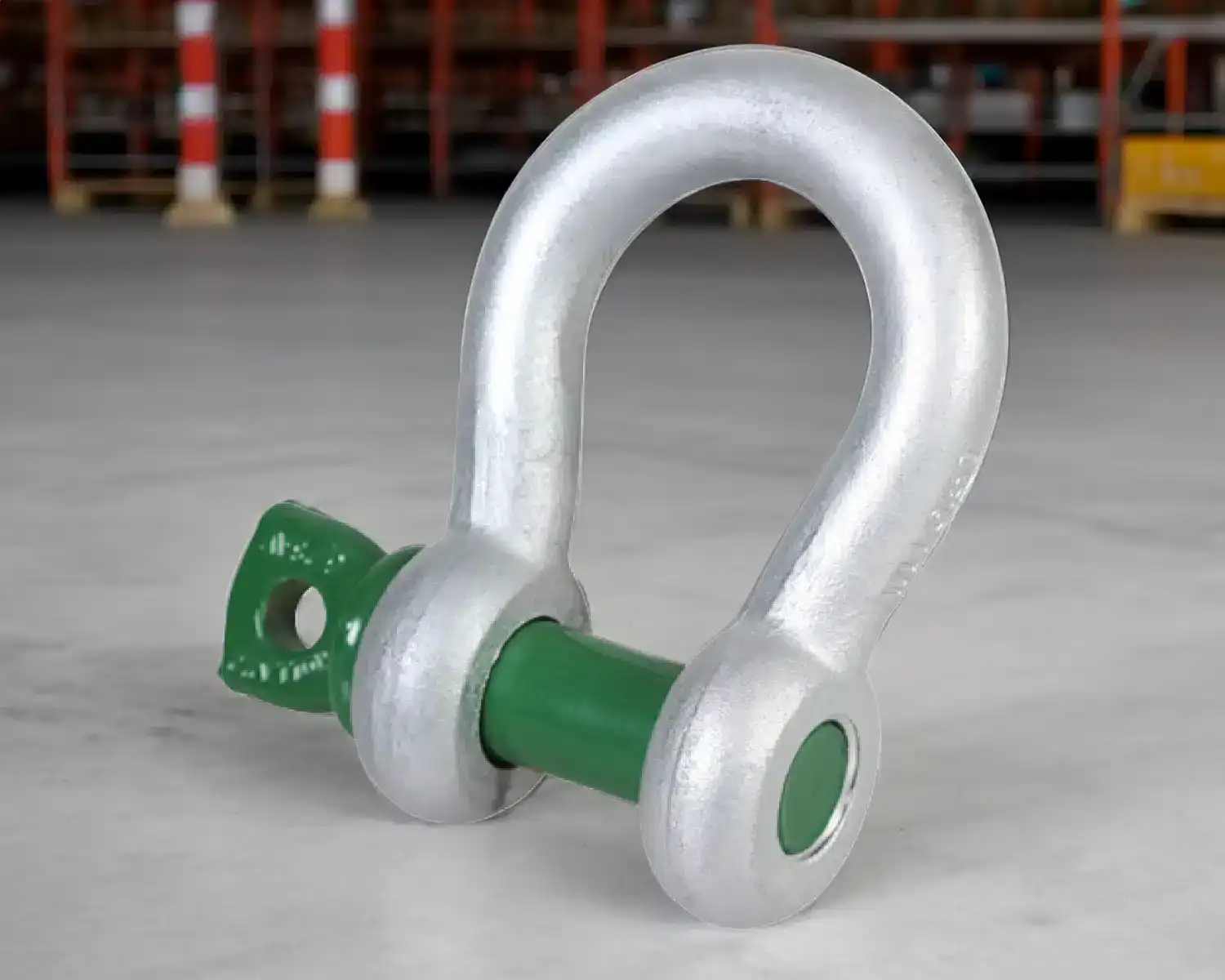 Metal shackle with green pin on floor
