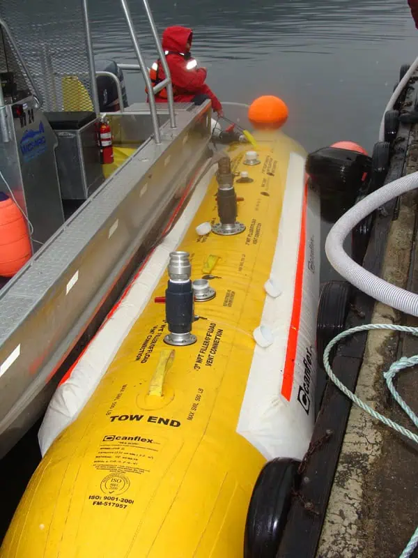 Worker handling yellow inflatable marine lift bag