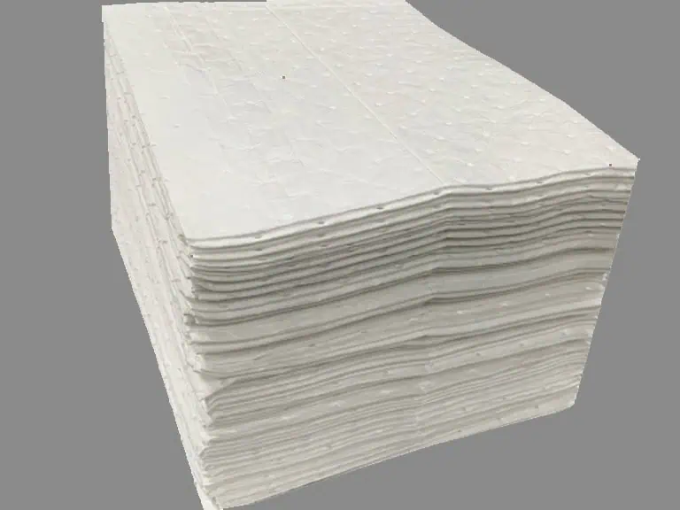 Stack of folded white absorbent pads