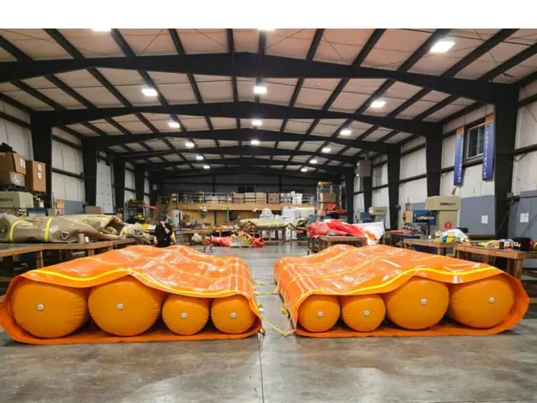 Large orange inflatable floats in warehouse workshop