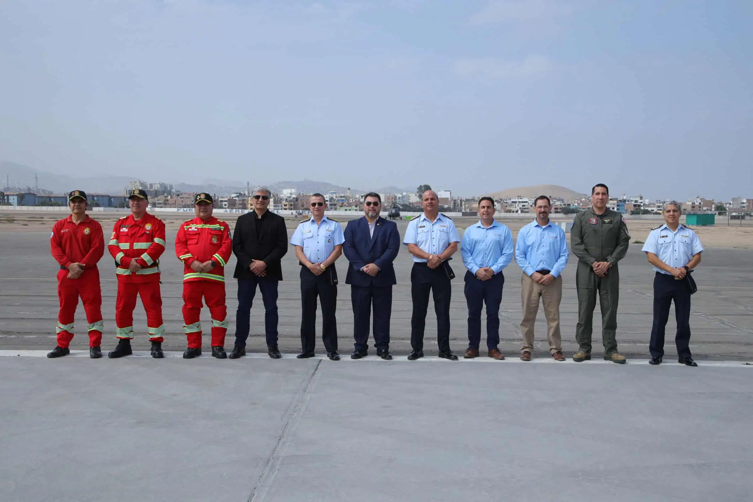 Airport emergency responders and aviation officials pose on runway